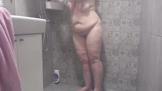 A hidden camera in the shower room spies on a mature wife with a plump figure and big tits and a fat booty Homemade fetish - 12 image