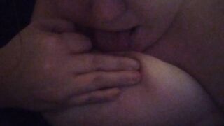 Girl licks and sucks her own nipple