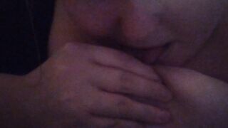 Girl licks and sucks her own nipple