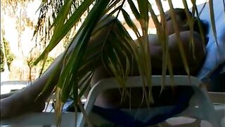 Playful thick newspaper brunette Elizabeth Rollings paddles her pickle sitting in the sun lounger - 14 image