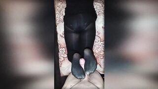A curvy beauty in black tights jerks off my dick with her legs. Footjob in opaque pantyhose.