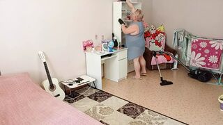 Mother-in-law vacuums the room naked
