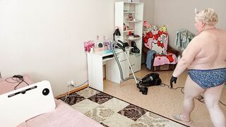 Mother-in-law vacuums the room naked