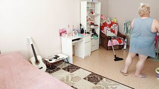 Mother-in-law vacuums the room naked