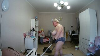 mother-in-law cleans the room naked