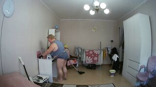 mother-in-law cleans the room naked