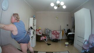mother-in-law cleans the room naked
