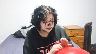 Clown girl Blowing up and popping huge balloon - 1 image