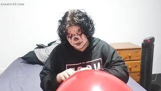 Clown girl Blowing up and popping huge balloon
