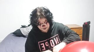 Clown girl Blowing up and popping huge balloon