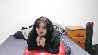 Clown girl Blowing up and popping huge balloon