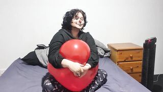 Clown girl Blowing up and popping huge balloon