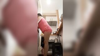 in the kitchen half-dressed