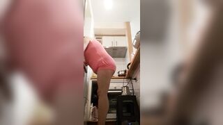 in the kitchen half-dressed