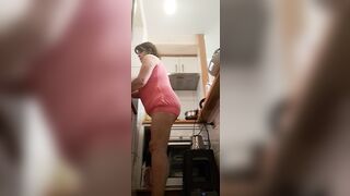 in the kitchen half-dressed